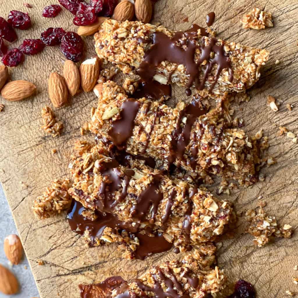 Granola bars with drizzled chocolate on a serving board