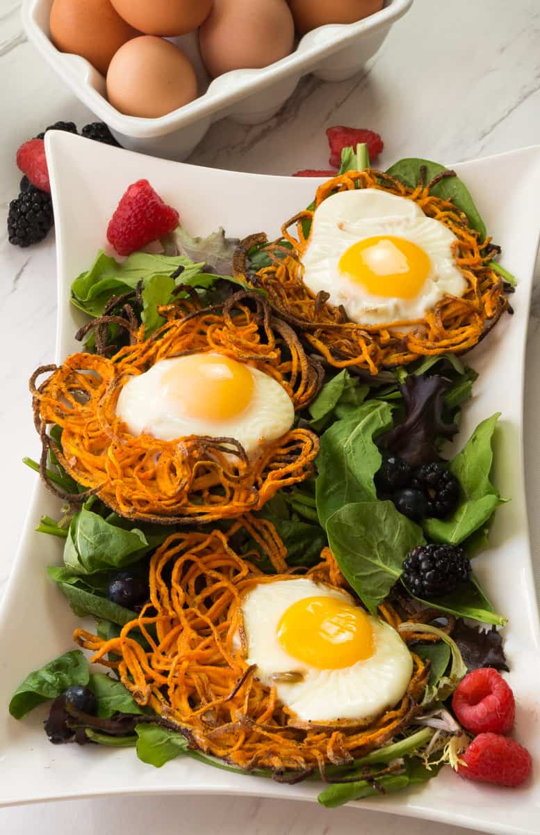 Paleo Sweet Potato Egg Nests- the perfect trio for the ultimate Sunday brunch of sunny eggs, sweet potatoes, and all the greens. Easter and Mother's Day brunch is done!|thekitcheneer.com