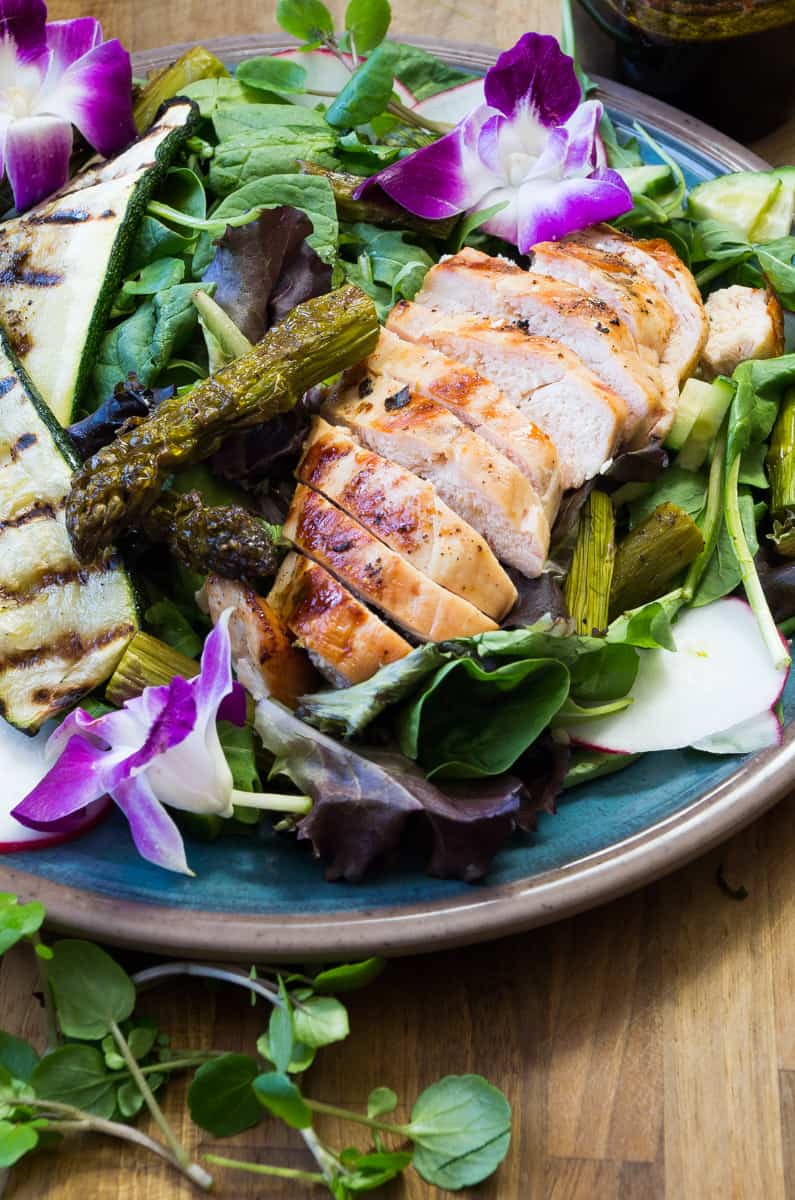 Spring Chicken Roasted Asparagus Salad- the perfect spring Whole30 recipe with a Beet Orange Basil Vinaigrette dressing that actually will make you CRAVE salad. Spring time vegetables are tossed with a Whole30 dressing and topped with grilled chicken.