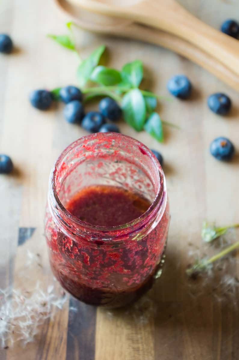 Veil of the Fairies Salad- A Whole30 vegetarian salad recipethat bursting with ripe Spring berries, dandelion greens, and topped with a delicious blueberry lemon basil beet dressing. 