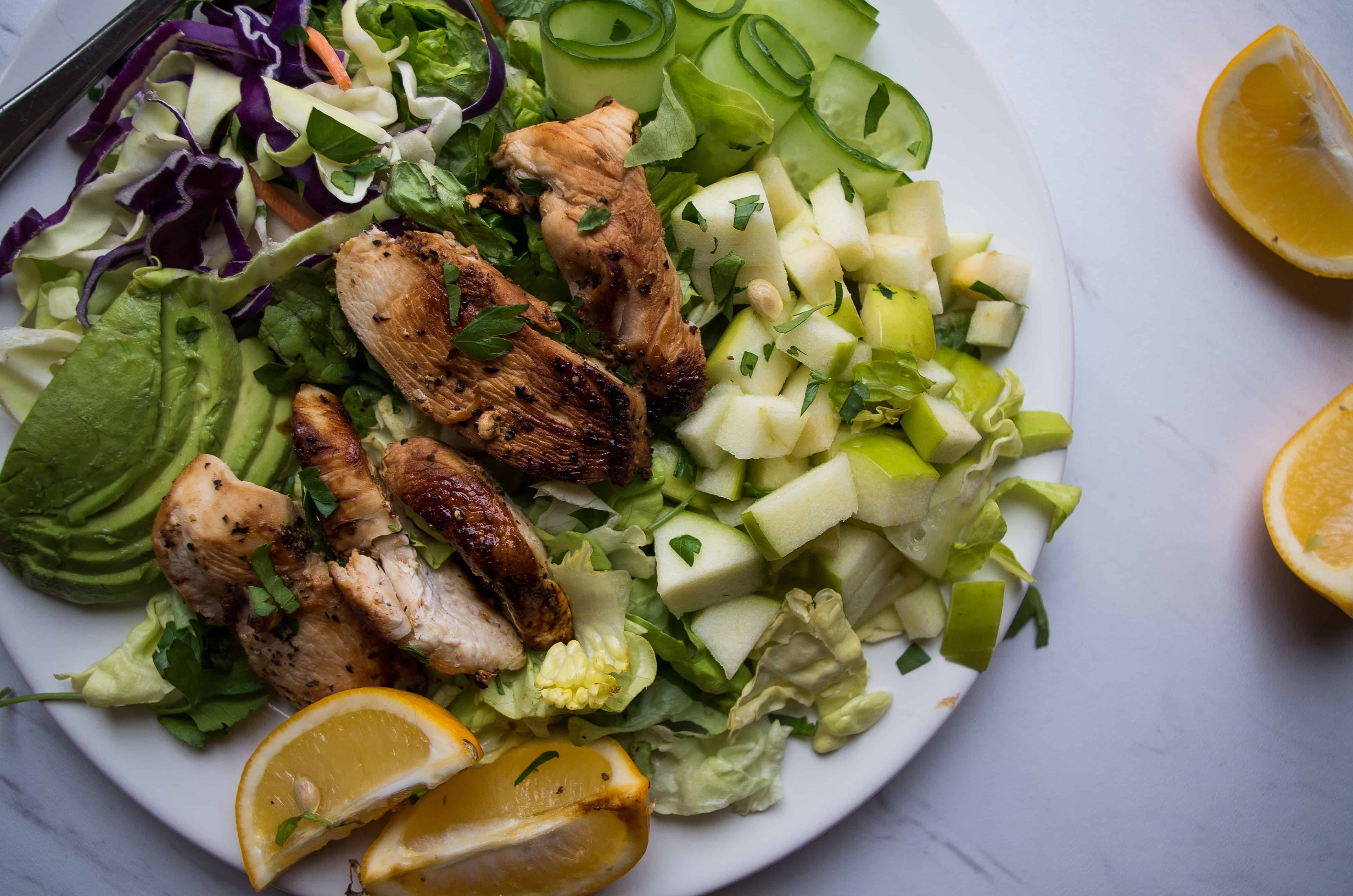 An herby, protein-packed power salad featuring all the green things, apples, avocados, and caramelized lemony chicken for your new go to Spring salad recipe! |thekitcheneer.com