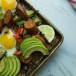 Whole30 Spicy Sheet pan Breakfast, a simple quick and colorful breakfast that prefect for meal prep, family gatherings, or an easy breakfast for dinner. A medley of potatoes and veggies are tossed with avocado oil, spices and roasted until crispy and caramelized in the oven. Then finished with chicken sausage and freshly cracked eggs. This is the breakfast dreams are made of.