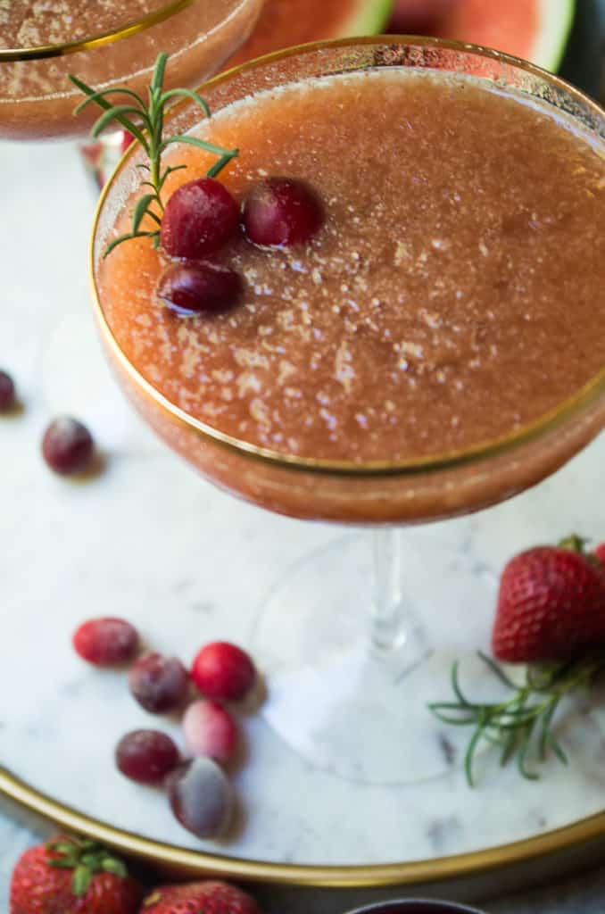 This Cranberry Strawberry Frose is a MUST for this summer’s cocktail sip. Cranberries and strawberries are combined into a simple syrup using coconut sugar then blended into an amazing frozen adult icee. Add a sprig of mint or rosemary to instantly up your drink game and add another level of flavor. I’m telling you EVERYONE needs this frose with a sprig of rosemary. It’s a GAME CHANGER.