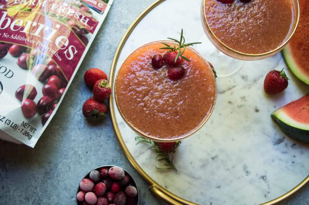 This Cranberry Strawberry Frose is a MUST for this summer’s cocktail sip. Cranberries and strawberries are combined into a simple syrup using coconut sugar then blended into an amazing frozen adult icee. Add a sprig of mint or rosemary to instantly up your drink game and add another level of flavor. I’m telling you EVERYONE needs this frose with a sprig of rosemary. It’s a GAME CHANGER.