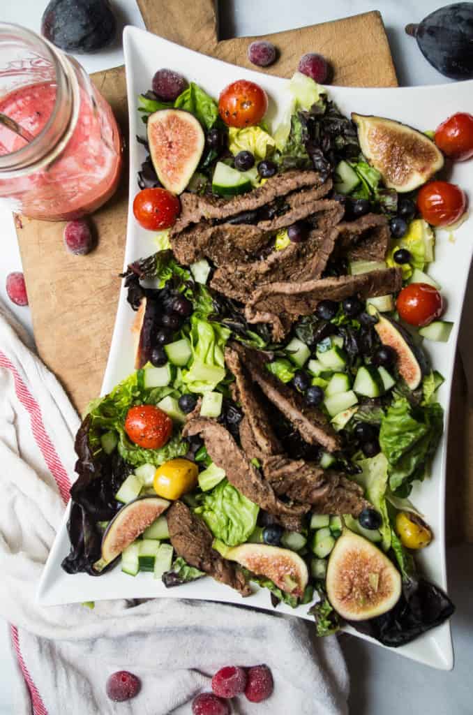 Cranberry Balsamic Steak Salad. The salad that I will be eating on repeat for the rest of the summer! Thinly sliced steak is marinated in cranberry juice, sriracha seasoning, balsamic vinegar and it’s all sorts of tangy and spicy! Meaning the most UN-boring summer salad ever. It’s colorful, easy, delicious, and perfect for a busy weeknight dinner!