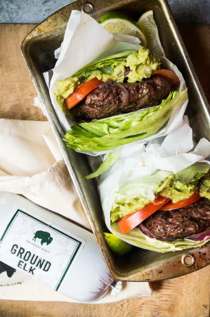 Tender, juicy, mouth-watering burgers. Topped with a dollop of a simple guacamole and wrapped in lettuce. These burgers make the perfect excuse to light up the grill this summer! Plot twist? These are elk burgers!!