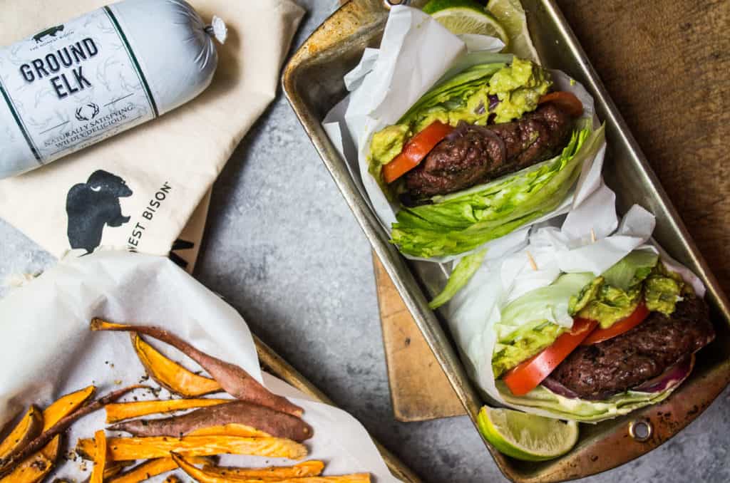 Tender, juicy, mouth-watering burgers. Topped with a dollop of a simple guacamole and wrapped in lettuce. These burgers make the perfect excuse to light up the grill this summer! Plot twist? These are elk burgers!!