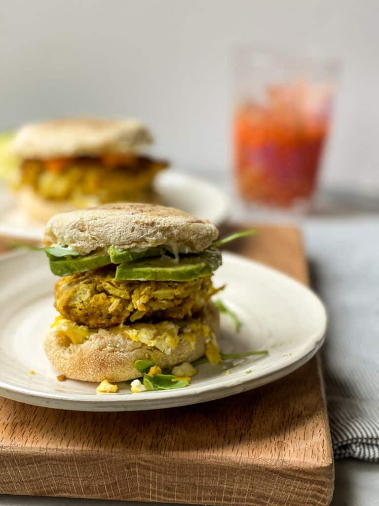 The Ultimate Vegetarian Breakfast Sandwich with a homemade meatless patty, soft scrambled eggs, avocado slices, tomato, and arugula. Good things happen when you make this breakfast sandwich.