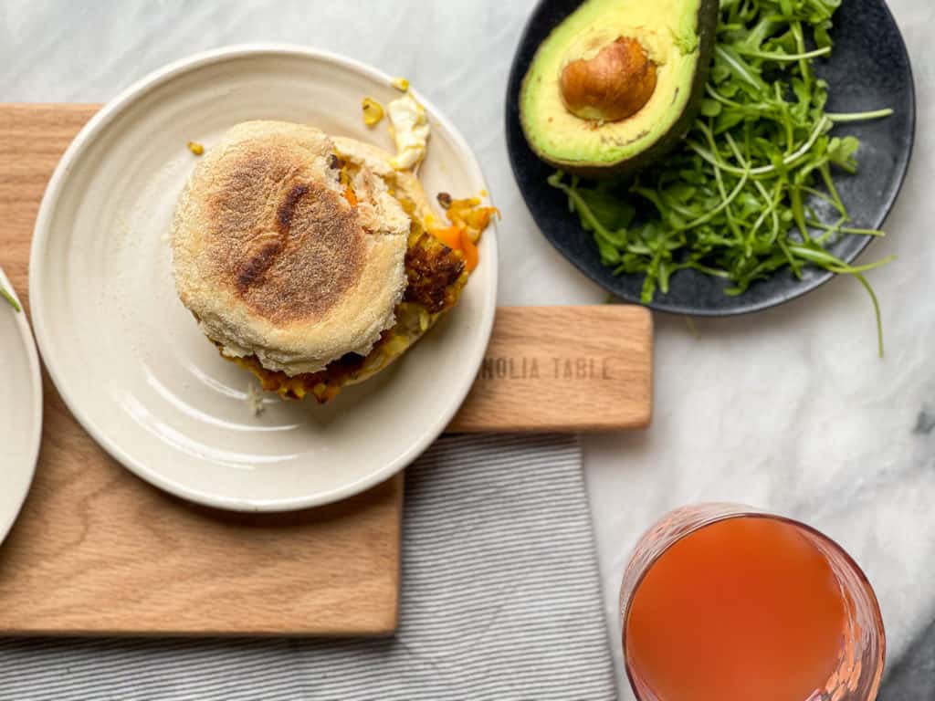 The Ultimate Vegetarian Breakfast Sandwich with a homemade meatless patty, soft scrambled eggs, avocado slices, tomato, and arugula. Good things happen when you make this breakfast sandwich.