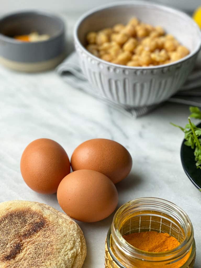 The Ultimate Vegetarian Breakfast Sandwich with a homemade meatless patty, soft scrambled eggs, avocado slices, tomato, and arugula. Good things happen when you make this breakfast sandwich.