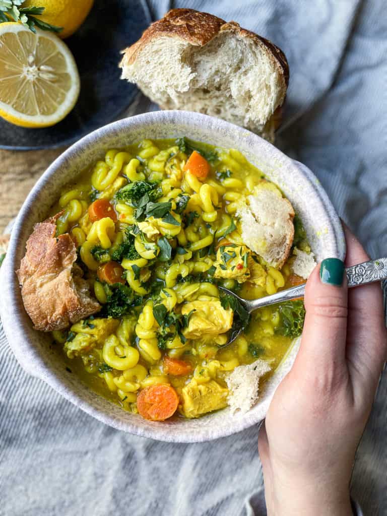 Chicken noodle soup in a bowl with a spoon