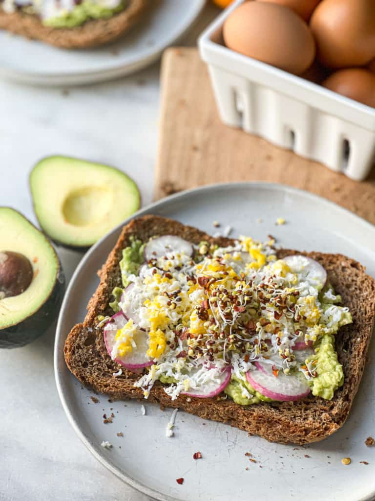 Smashed avocado on toast served on a plate