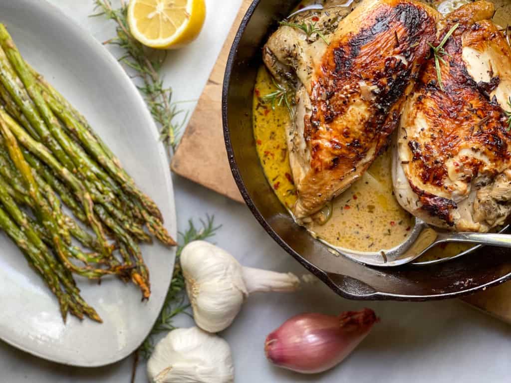 Seared Chicken Breasts in a Creamy Garlic Sauce in a cast iron skillet 