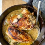 Seared Chicken Breasts in a Creamy Garlic Sauce in a cast iron skillet