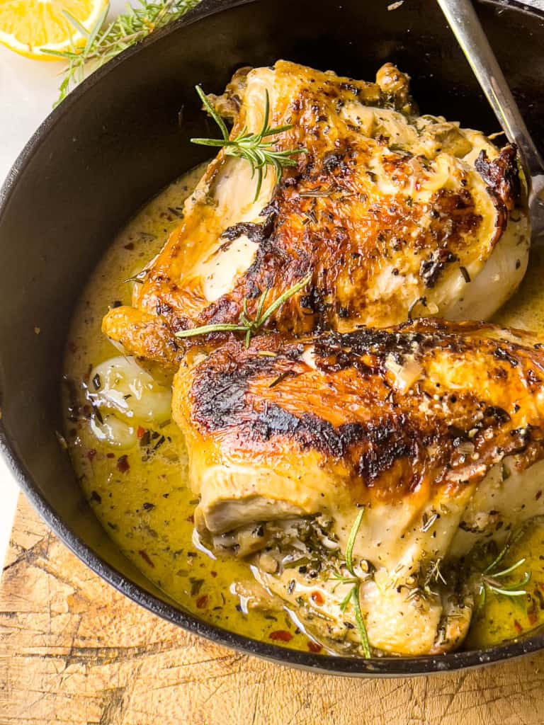 Seared Chicken Breasts in a Creamy Garlic Sauce in a cast iron skillet 