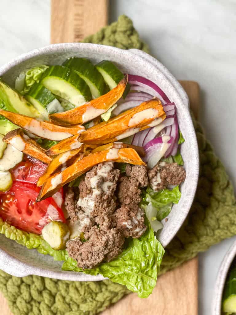 Burger salad in a large bowl with vegetables 