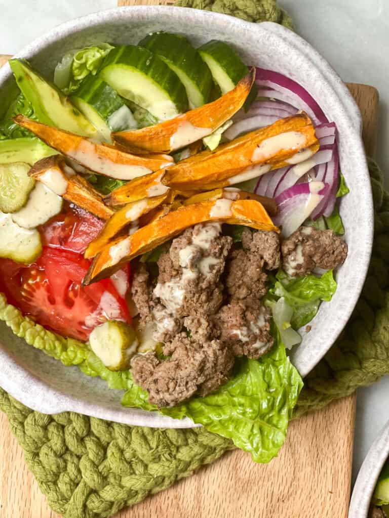 Burger salad in a large bowl with vegetables