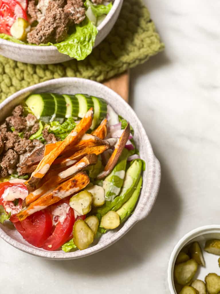 Burger in a bowl with sweet potato fries