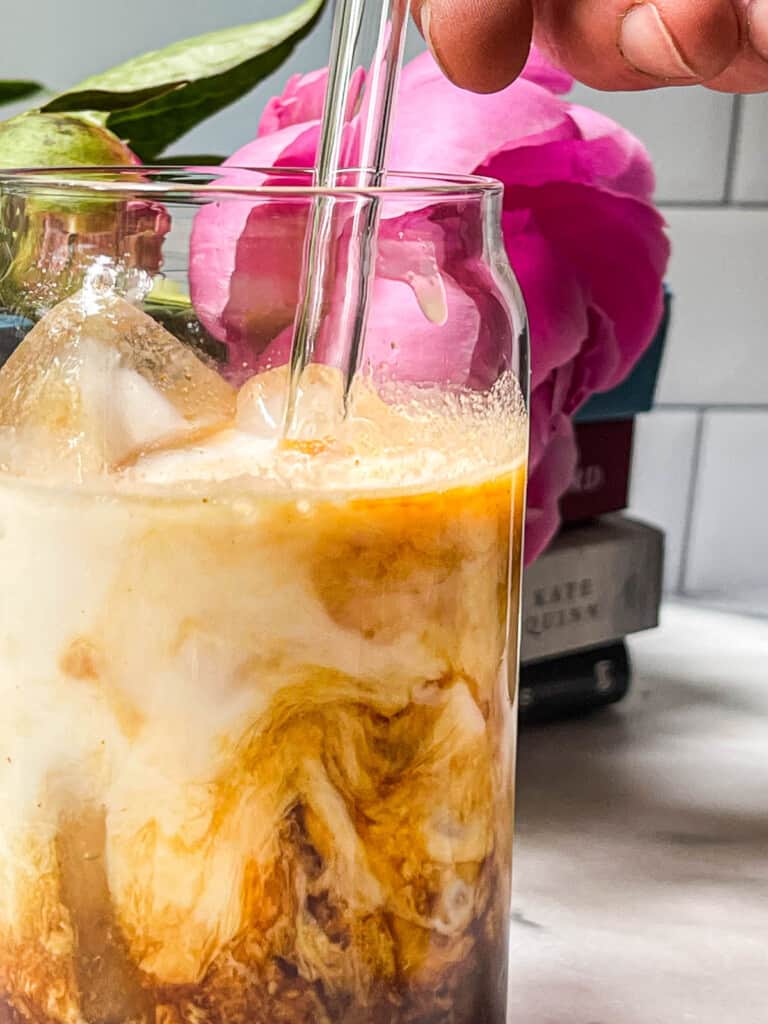 Iced Chocolate Almond Milk Shaken Espresso in a clear tall glass with a glass straw 