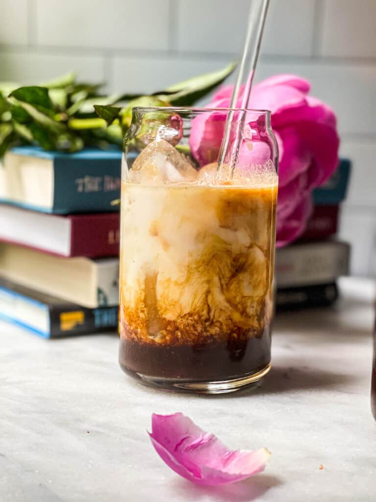 Iced Chocolate Almond Milk Shaken Espresso in a clear tall glass with a glass straw 