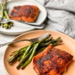 Chili Lime Air Fryer Salmon on a plate with a side of asparagus on a white marble table top.