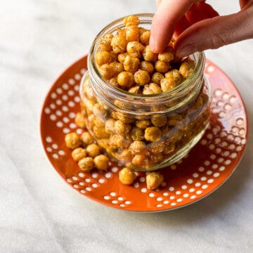 Clear glass Mason Jar filled with crispy air fryer chickpeas for an addictive snack!