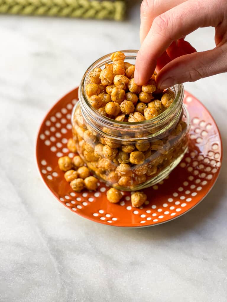 Clear glass Mason Jar filled with crispy air fryer chickpeas for an addictive snack!